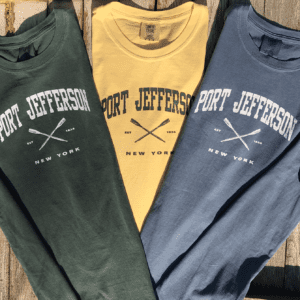 multi-colored shirts with Port Jefferson text on a wooden surface
