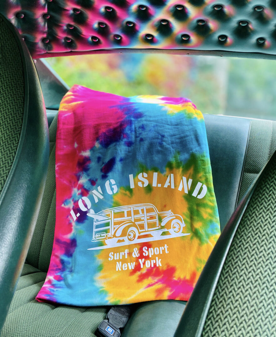 Tie-Dye Blanket in a car that reflects color on the back windshield