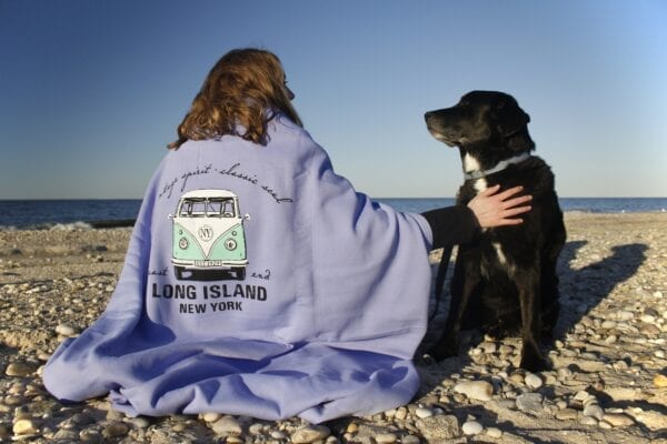 long island blanket drapped around a young woman with a dog