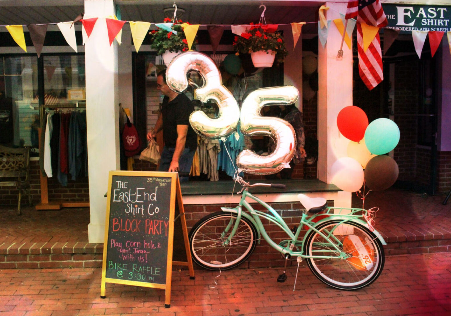 35 ballons on a bike in front of the store